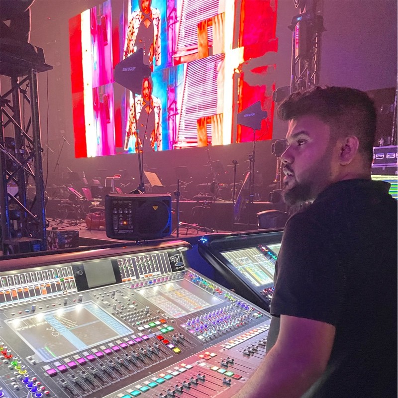 Sovan operating a large-format digital mixing console at a live show